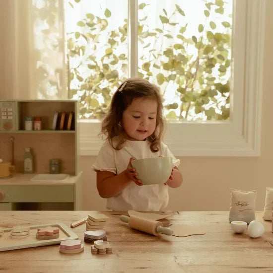 Child playing with the Little Dutch Wooden Baking Set