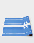 Summer paper table runner with white stripes on a blue background.