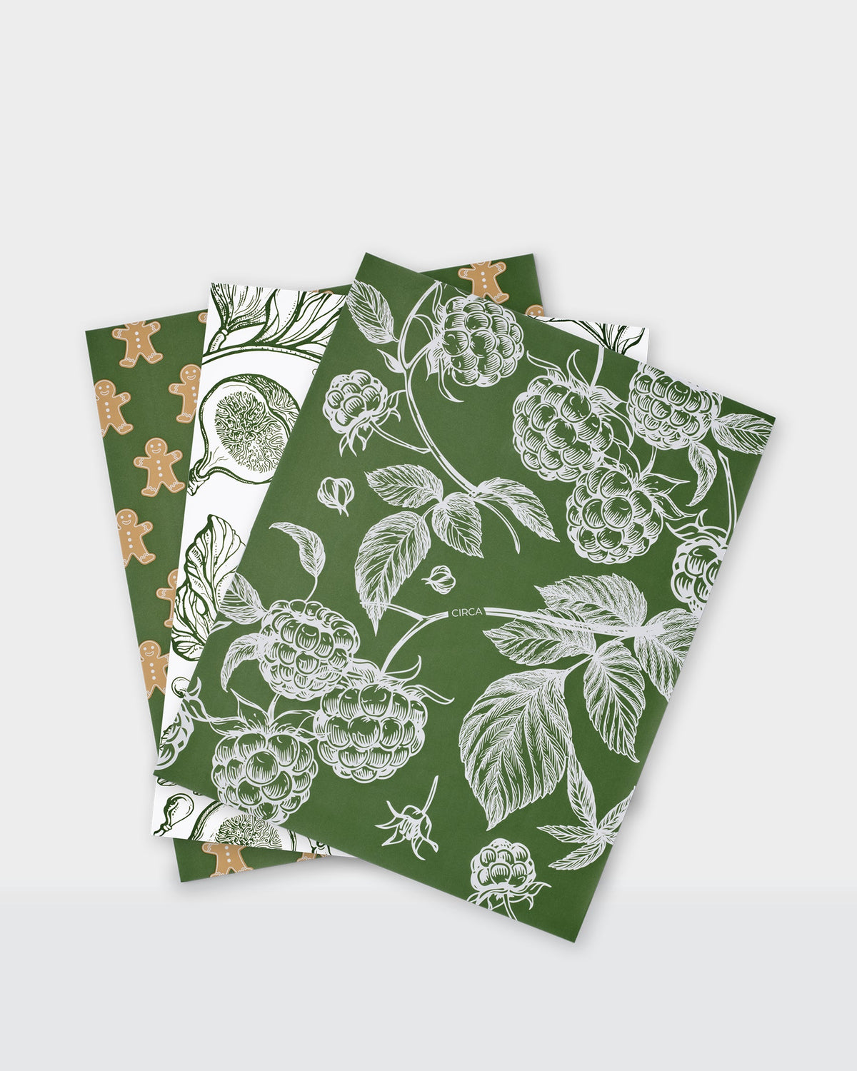 Festive greaseproof paper featuring green botanical prints and gingerbread designs.
