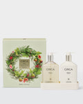 Mango & Papaya Hand Wash and Hand Lotion on their ceramic tray beside a front-facing Christmas gift box.