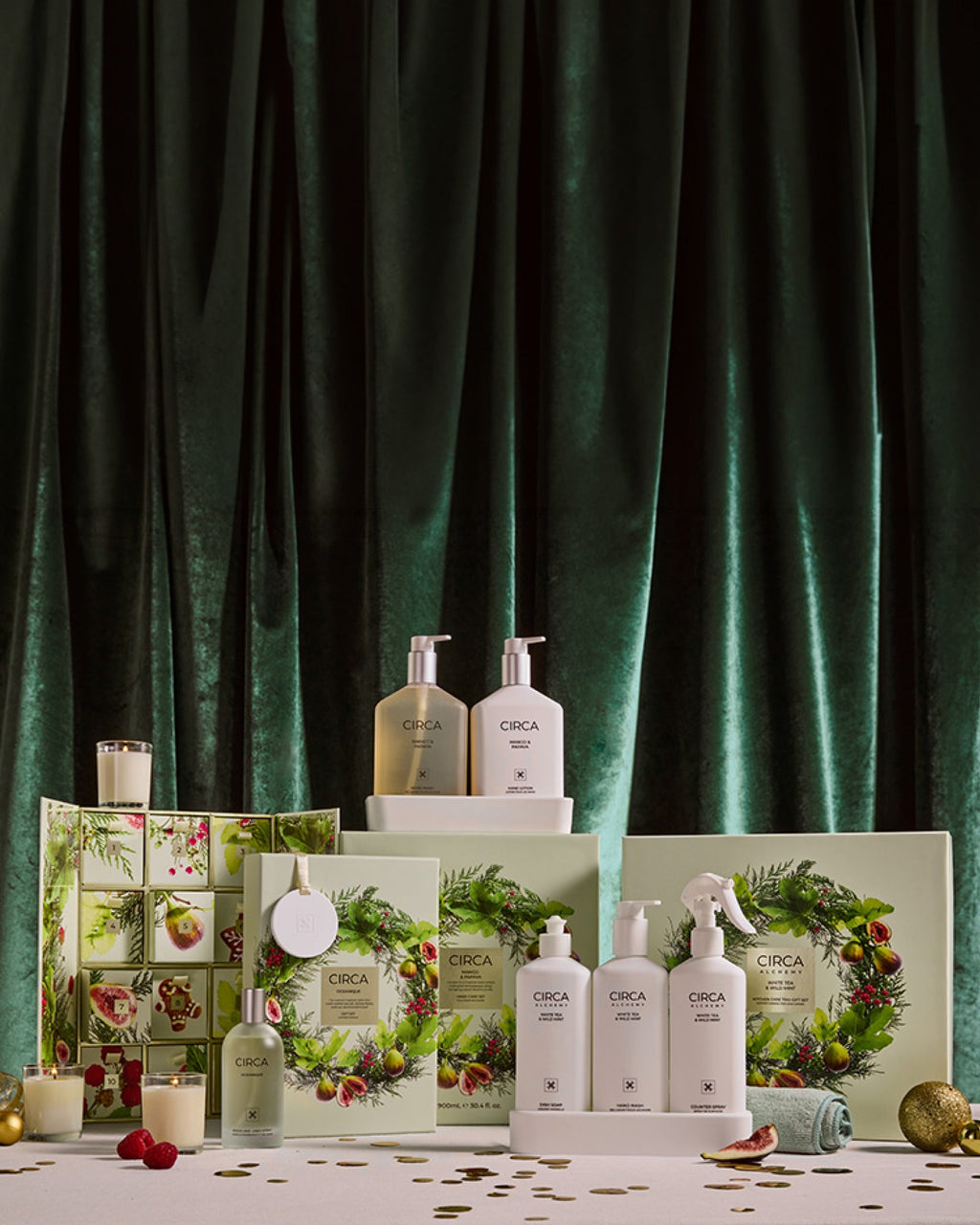 White Tea & Wild Mint Kitchen Trio with other Christmas gift sets in a festive display against green velvet.