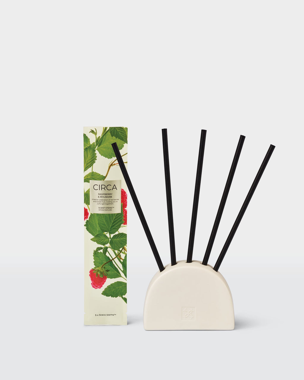 Raspberry & Rhubarb replacement Scent Stems displayed in a ceramic holder, sold separately, beside their packaging.