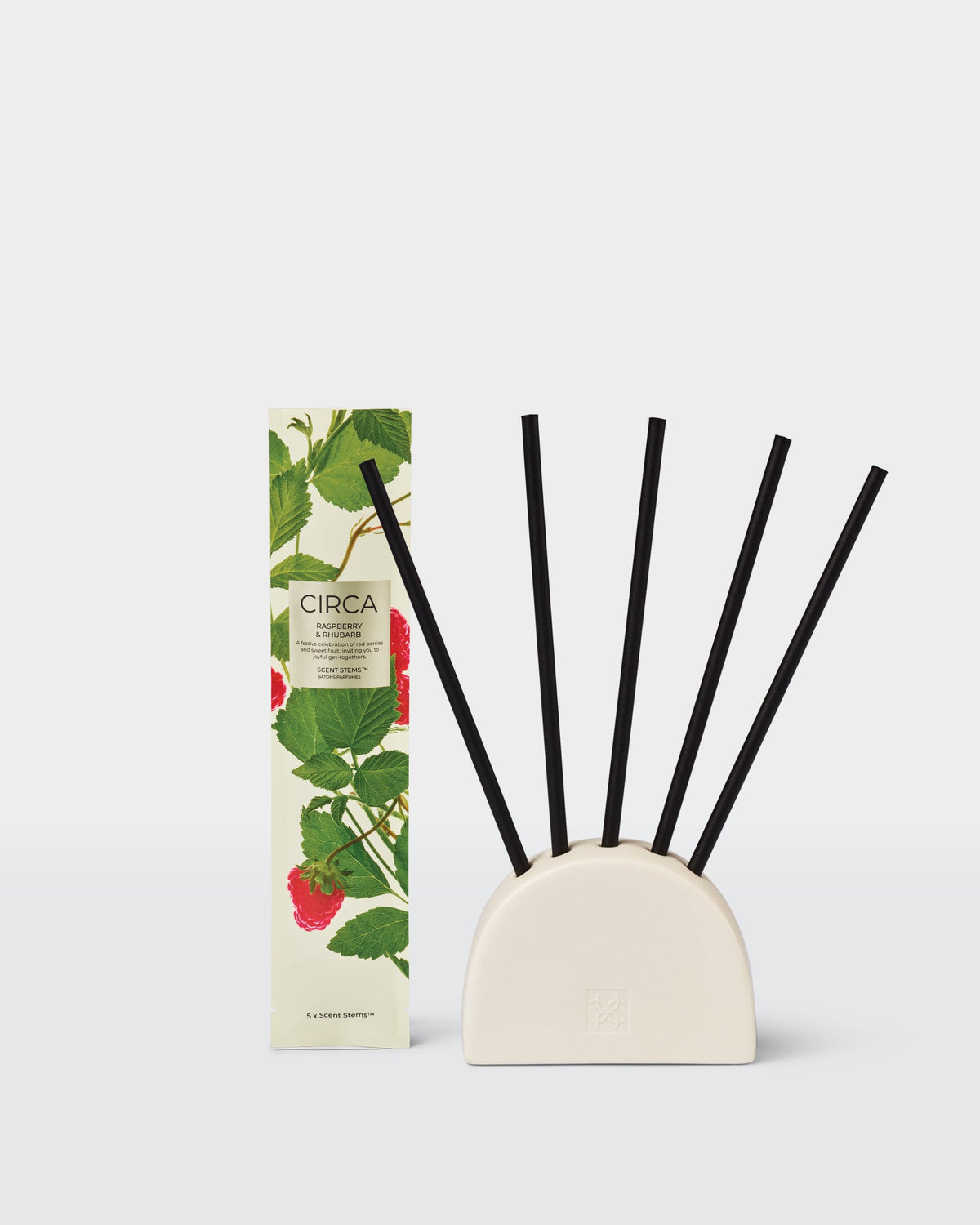 Raspberry & Rhubarb replacement Scent Stems displayed in a ceramic holder, sold separately, beside their packaging.