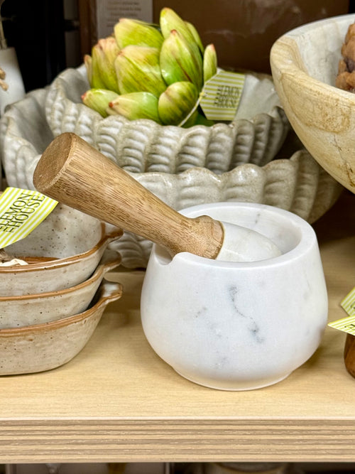 White marble mortar and pestle with wooden handle, front view
